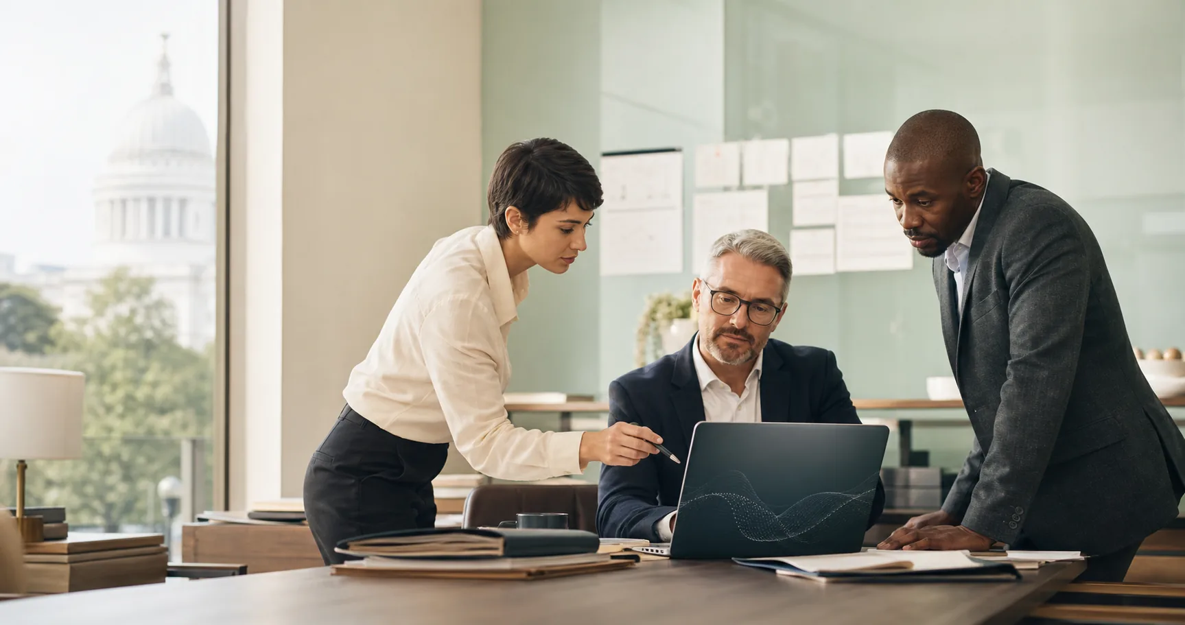 Three law-firm professionals reviewing an AI-assisted legal workflow around a laptop in a bright modern office.